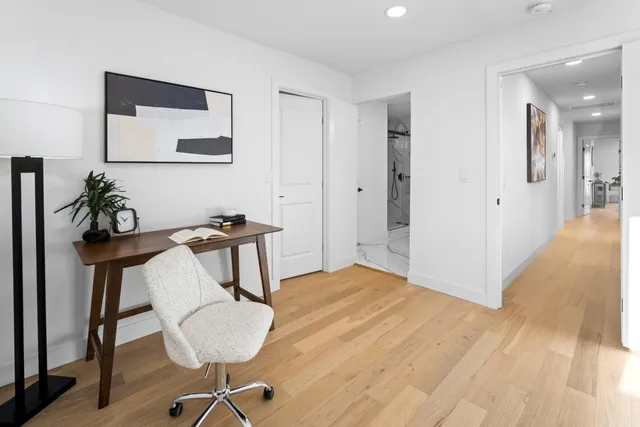 a bedroom with furniture and a mirror