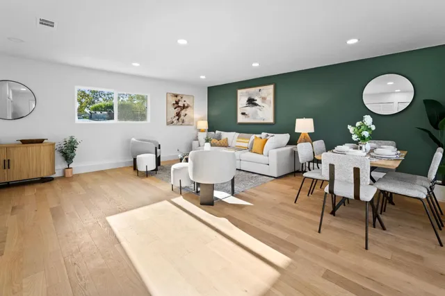 a living room with furniture a window and a lamp