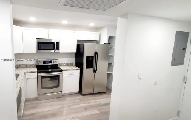 a kitchen with a stove microwave and refrigerator