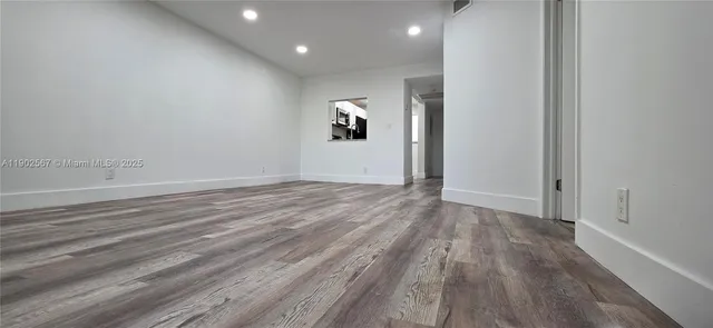 a view of room with wooden floor