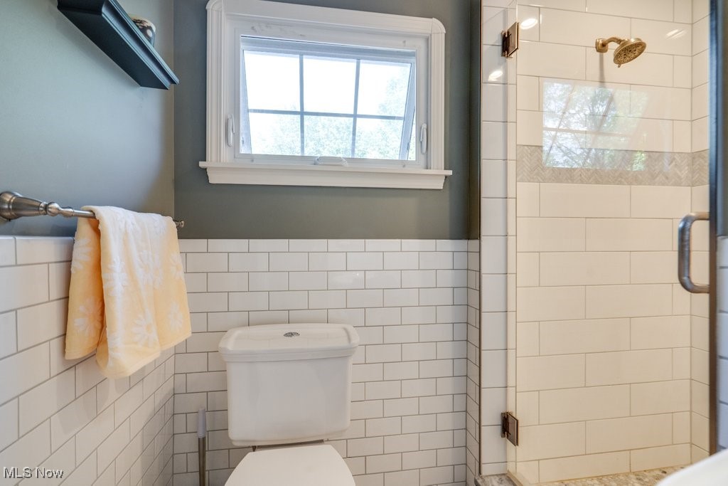2500 Eaton Road Cleveland, OH 44118 - Photo 32 of 50 Bathroom with a stall shower, tile walls, toilet, and wainscoting