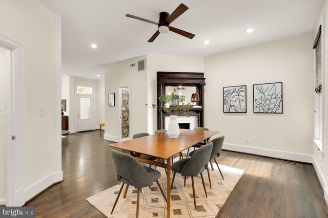 a kitchen with a sink a refrigerator and cabinets