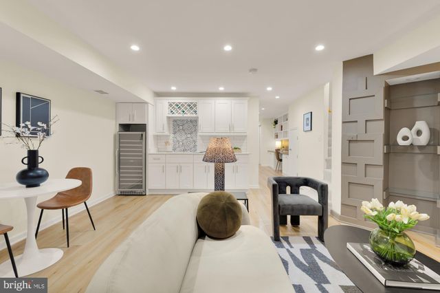 a kitchen with stainless steel appliances granite countertop a sink and a white cabinets