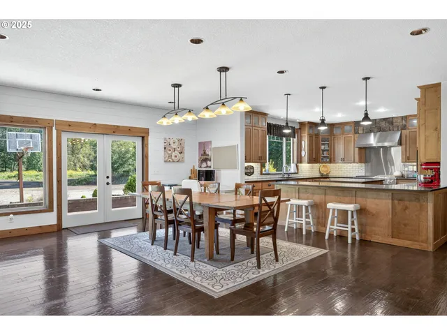 a dining room with furniture window and wooden floor