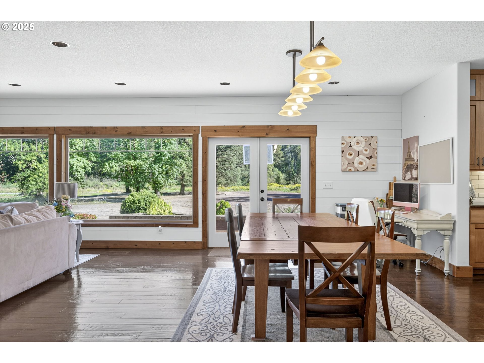 15047 South Macksburg Road Mulino, OR 97042 - Photo 18 of 48 a dining room with wooden floor a chandelier a wooden table and chairs