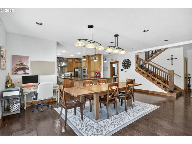 a dining room with wooden floor a glass table and chairs