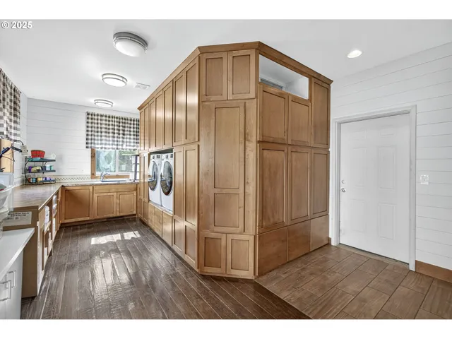 a view of a refrigerator in kitchen and wooden floor