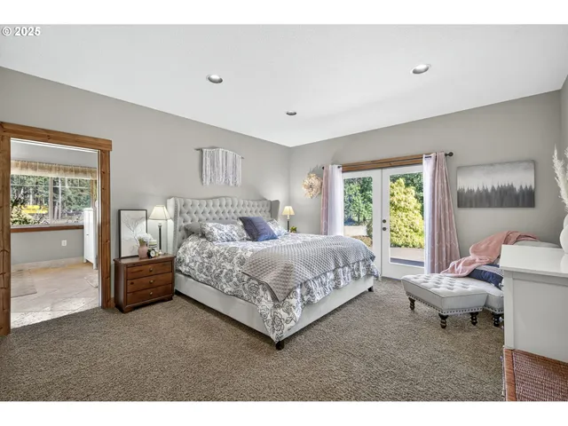 a bedroom with a large bed and a couch