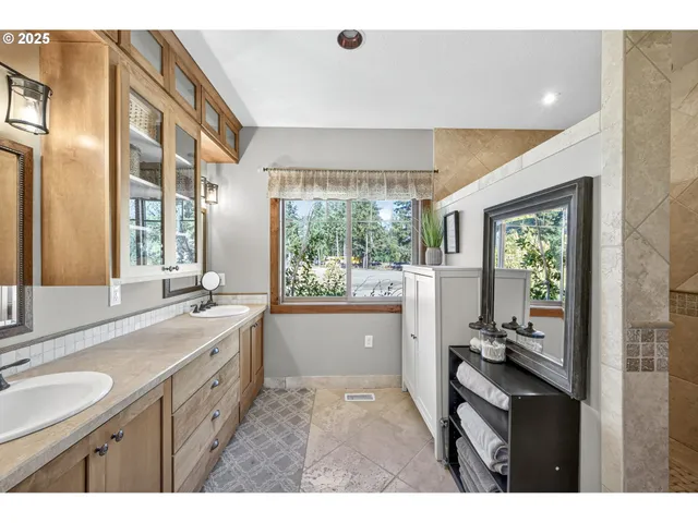 a bathroom with a granite countertop sink mirror and a bathtub