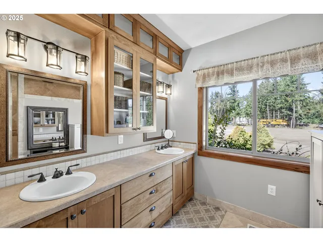 a bathroom with a sink double vanity and a mirror