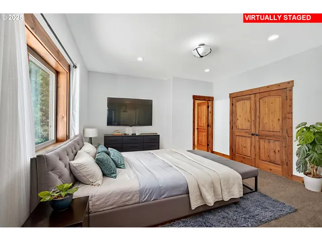 a bedroom with a large bed and a window