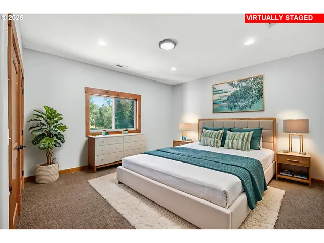 a bedroom with a large bed and a potted plant