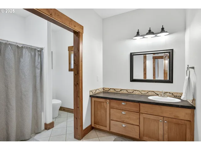 a bathroom with a sink vanity and mirror
