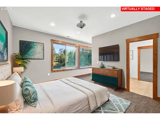 a bedroom with a bed and a flat screen tv