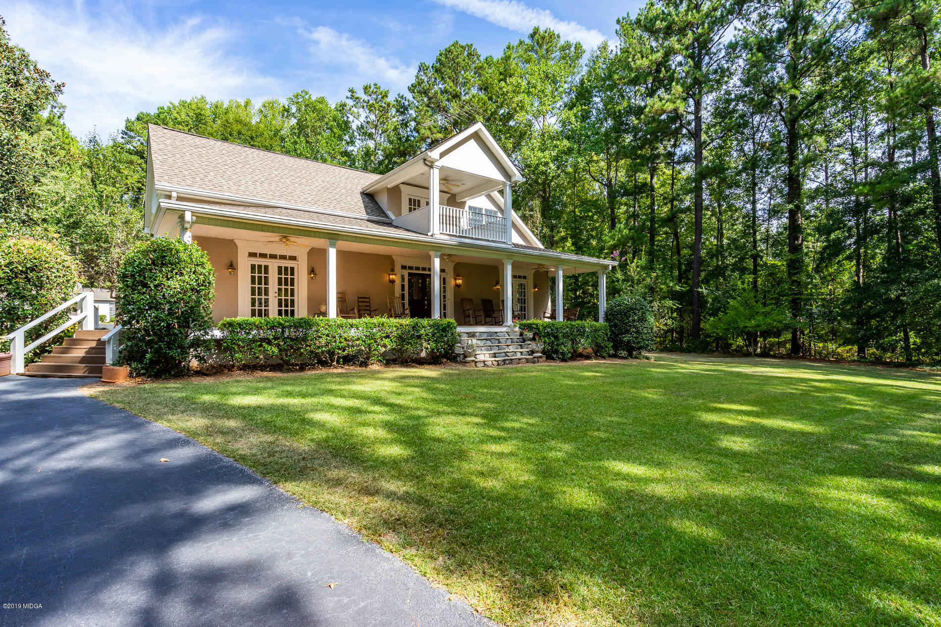 a front view of a house with a garden