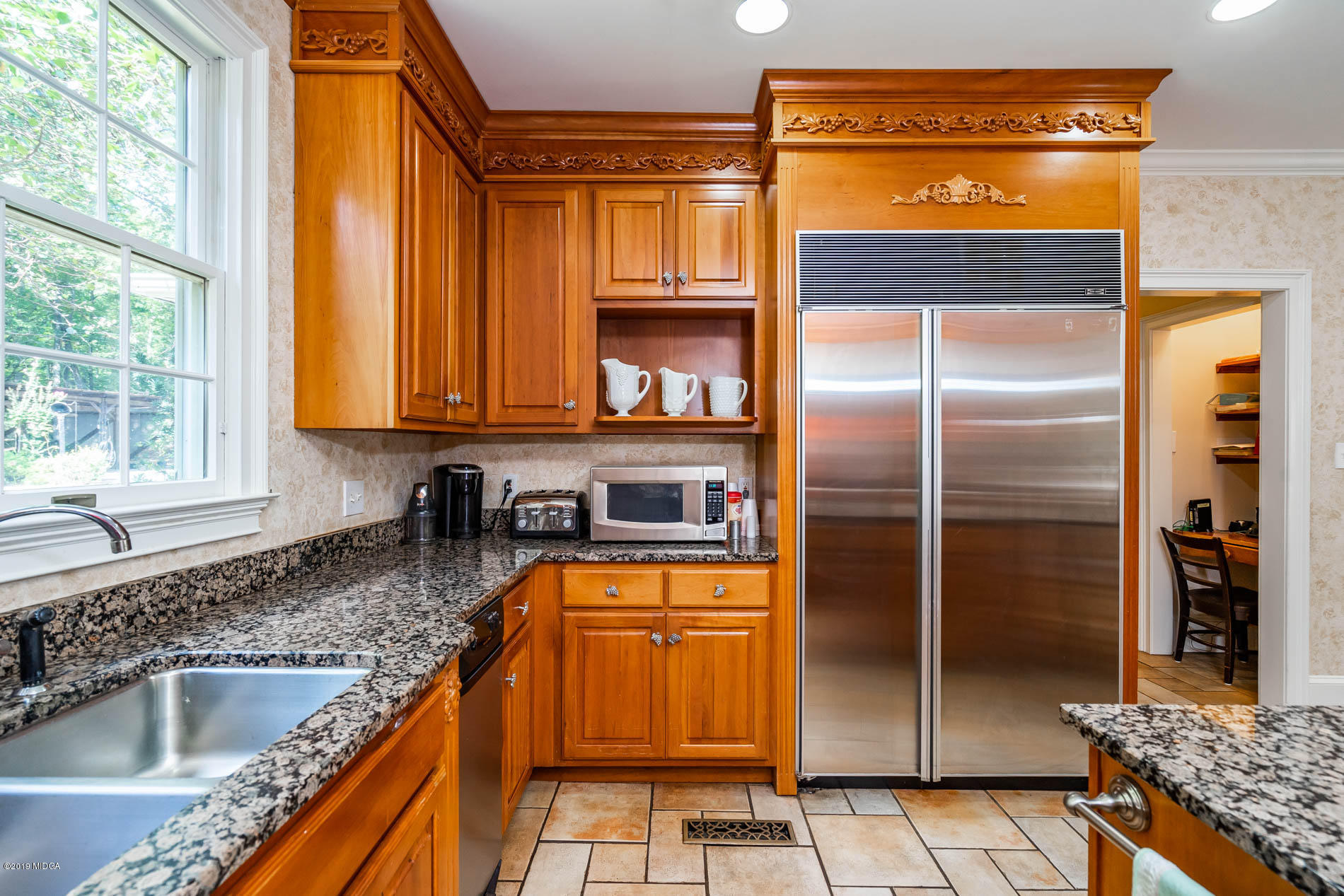 9748 Estes Road Macon, GA 31220 - Photo 14 of 144 a kitchen with granite countertop a refrigerator and a sink