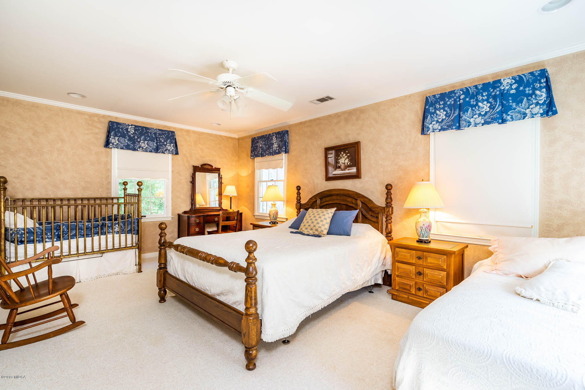 9748 Estes Road Macon, GA 31220 - Photo 40 of 144 a bedroom with bed and a chandelier