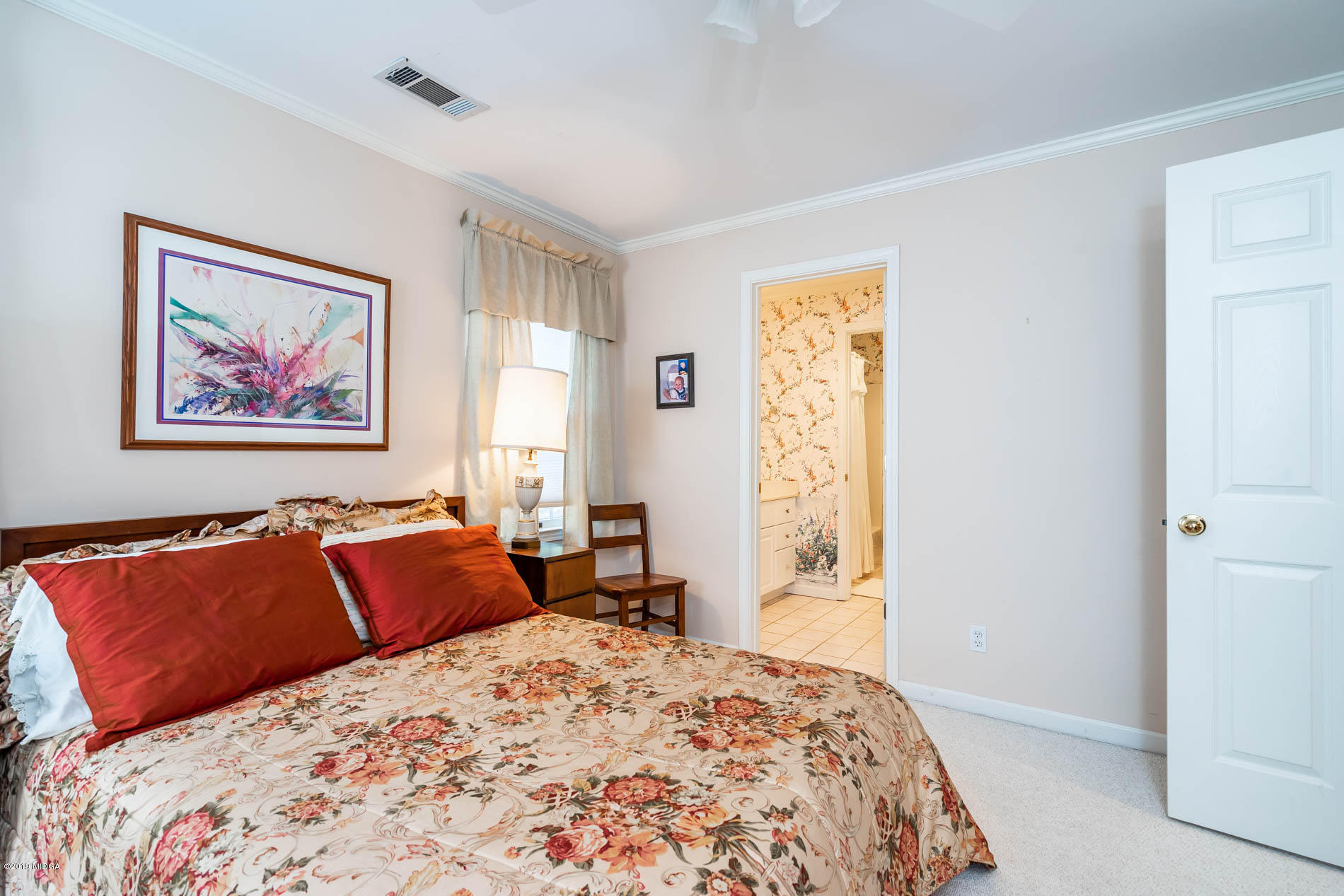9748 Estes Road Macon, GA 31220 - Photo 42 of 144 a bedroom with a bed and painting on the wall