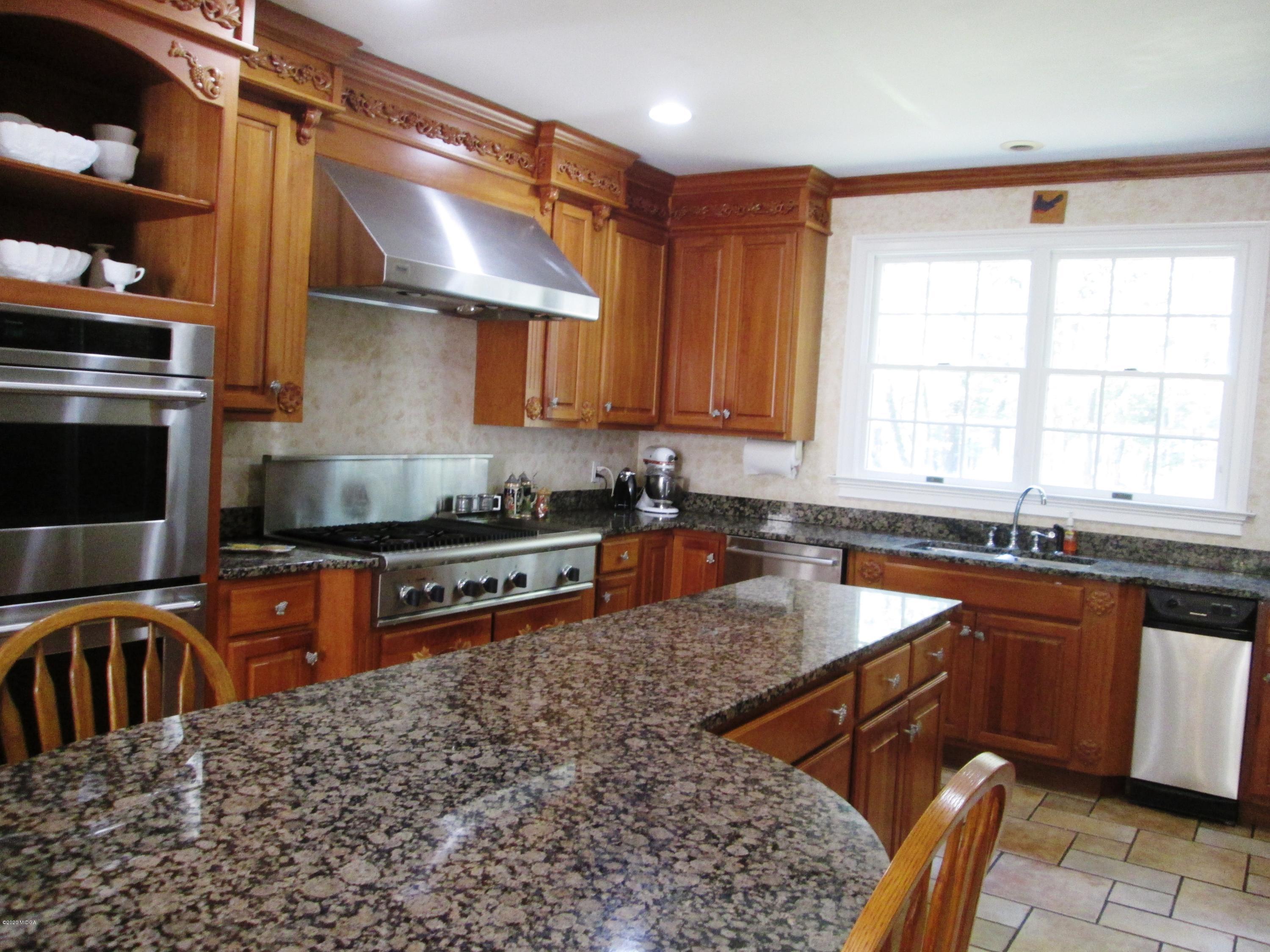 9748 Estes Road Macon, GA 31220 - Photo 88 of 144 a kitchen with stainless steel appliances granite countertop a sink a stove and a refrigerator