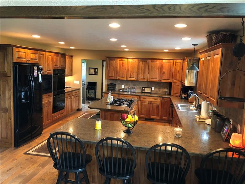 246 Burdette Road Stoneboro, PA 16153 - Photo 15 of 24 Plenty of cabinets and counterspace custom kitchen with gas cooktop, convection oven, microwave/convection combo. Hardwood floors.