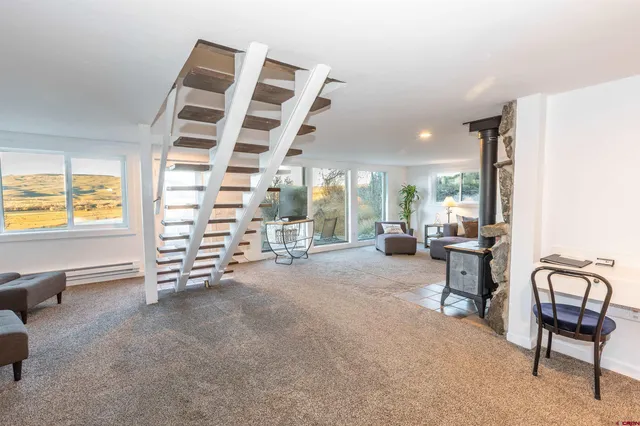 a view of a livingroom with furniture and a window