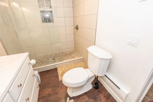 a bathroom with a sink a toilet and shower