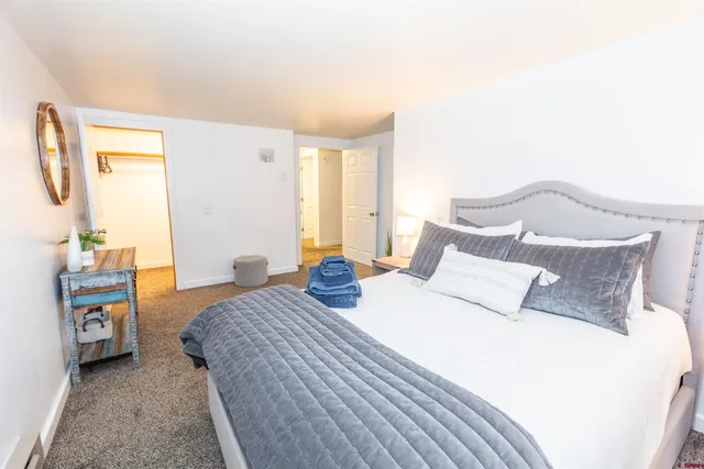 a bedroom with a bed and a couch