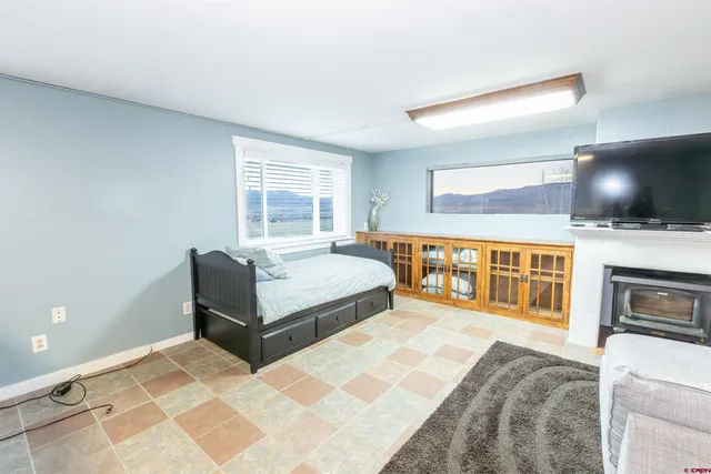 a bedroom with a bed and a television