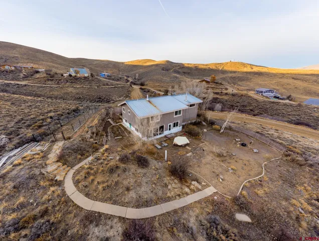 an aerial view of a house with mountain view