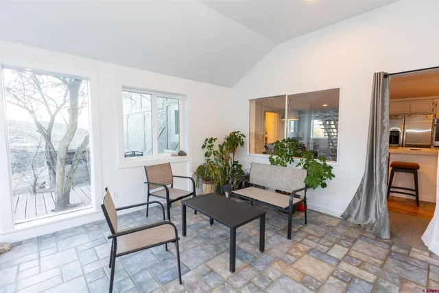 a living room with furniture and a potted plant