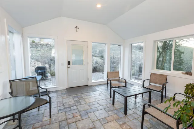 a living room with furniture and a floor to ceiling window