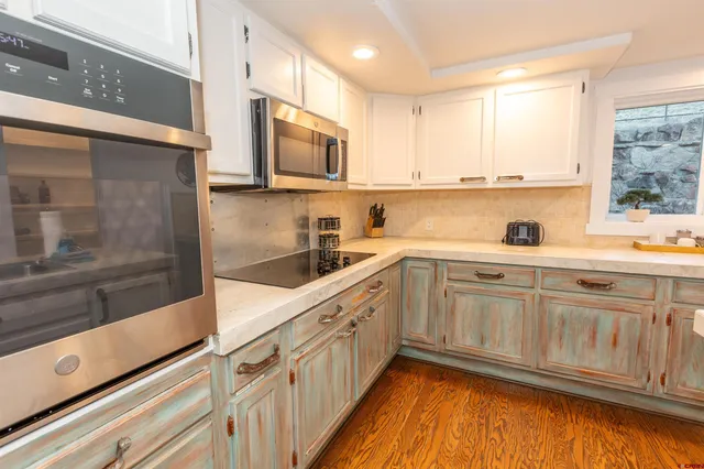 a kitchen with cabinets a sink and appliances