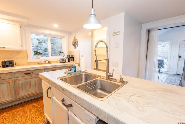 a kitchen with a sink stove and cabinets