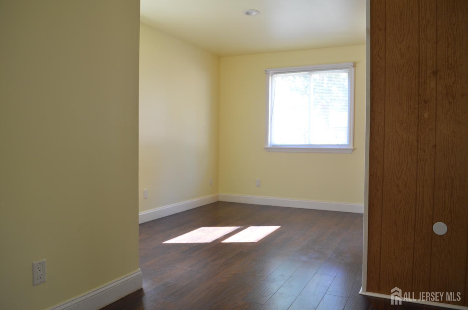 550 4th Street Dunellen, NJ 08812 - Photo 12 of 30 an empty room with wooden floor and windows