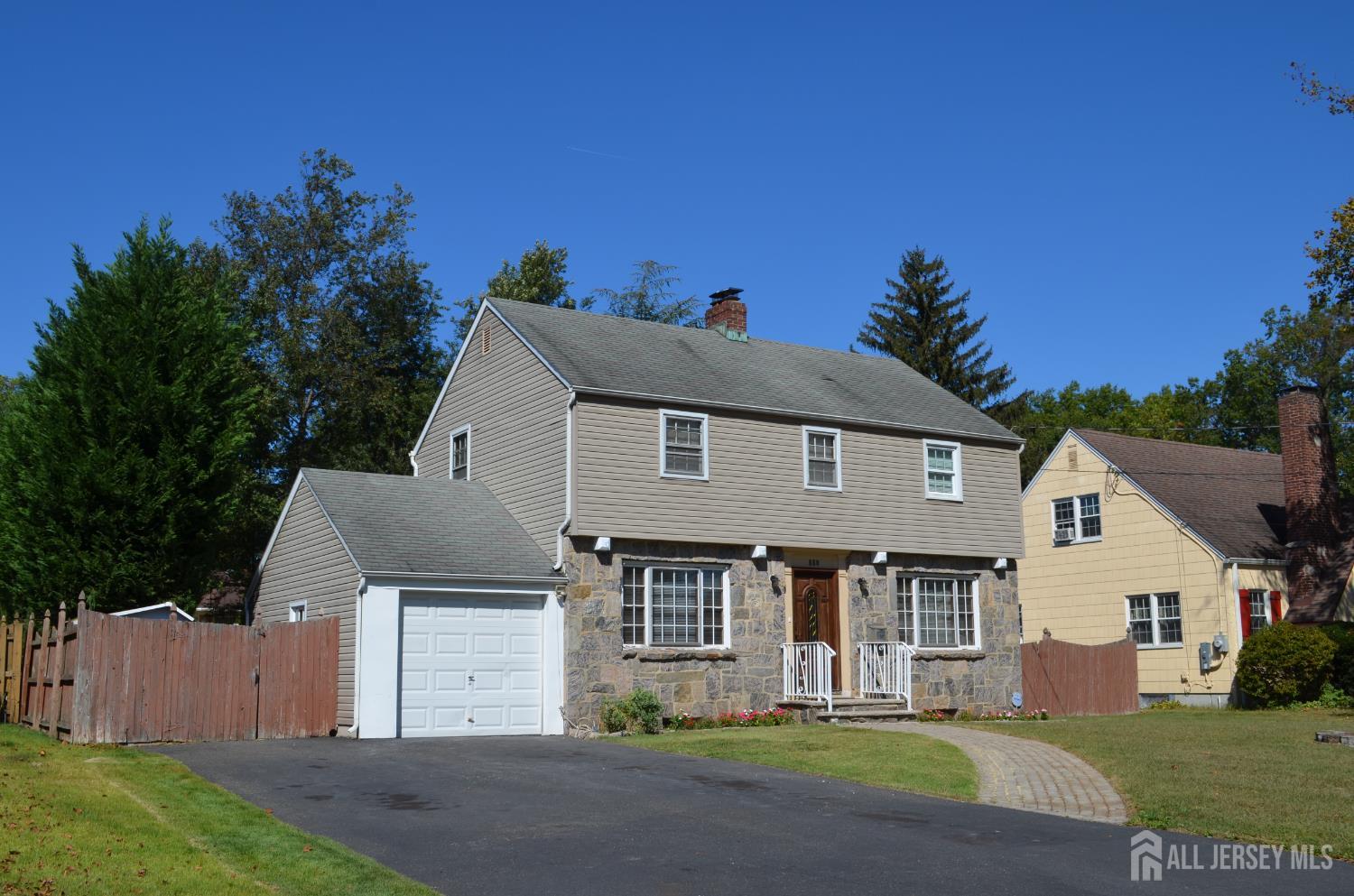 550 4th Street Dunellen, NJ 08812 - Photo 2 of 30 a front view of a house with a garden