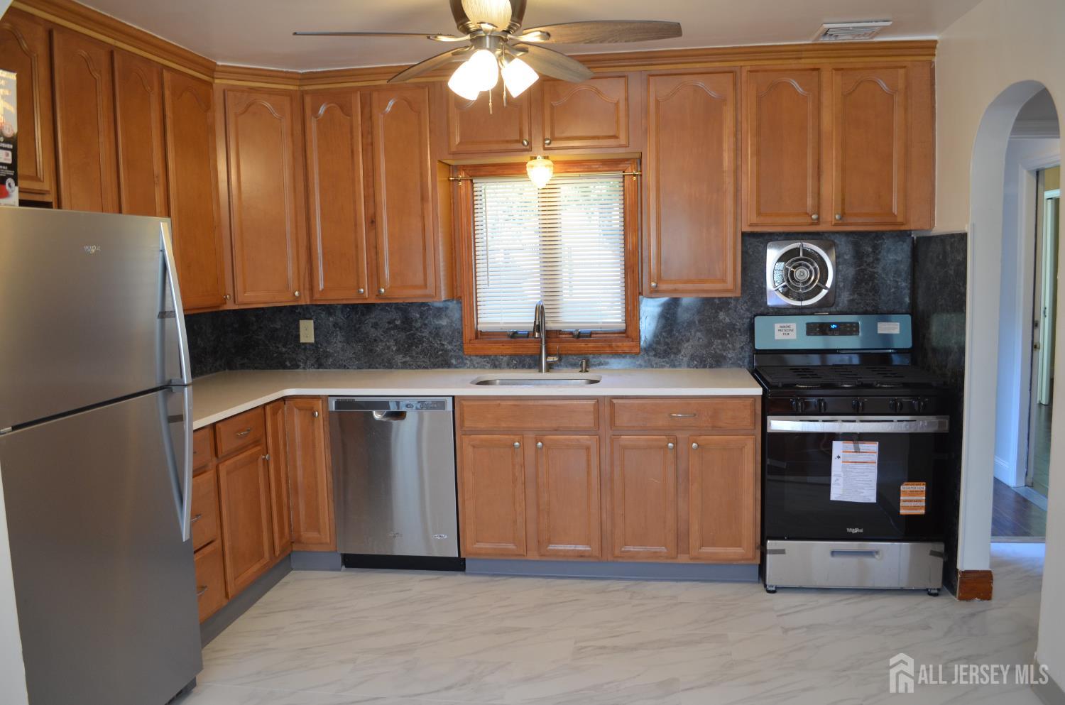 550 4th Street Dunellen, NJ 08812 - Photo 22 of 30 a kitchen with stainless steel appliances granite countertop a refrigerator a stove a sink and dishwasher