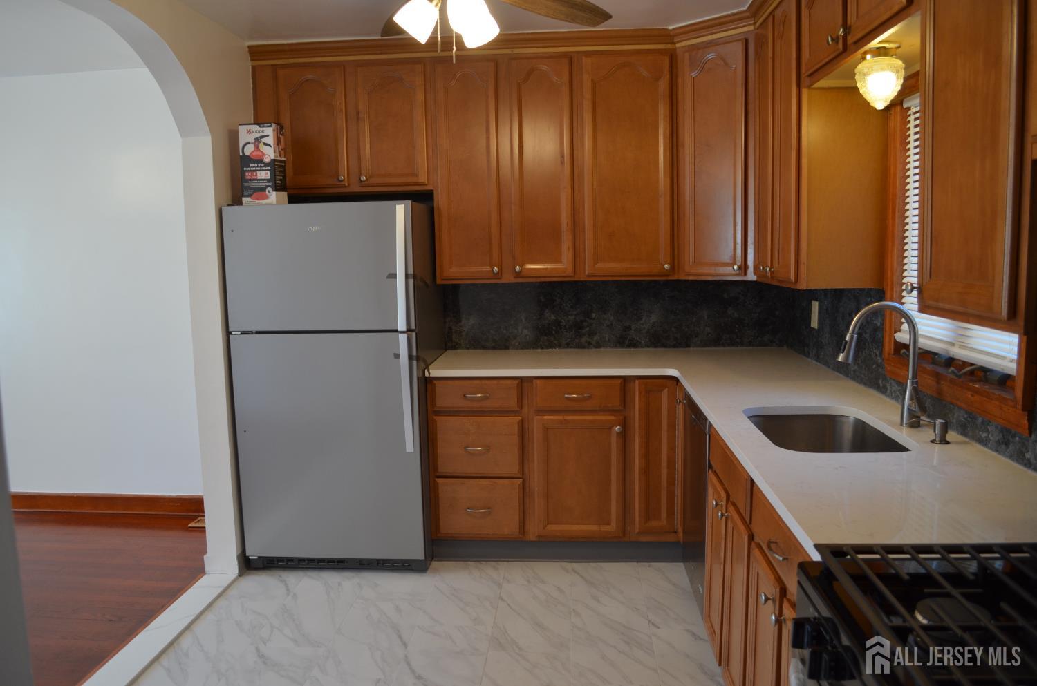 550 4th Street Dunellen, NJ 08812 - Photo 23 of 30 a kitchen with a refrigerator sink and cabinets