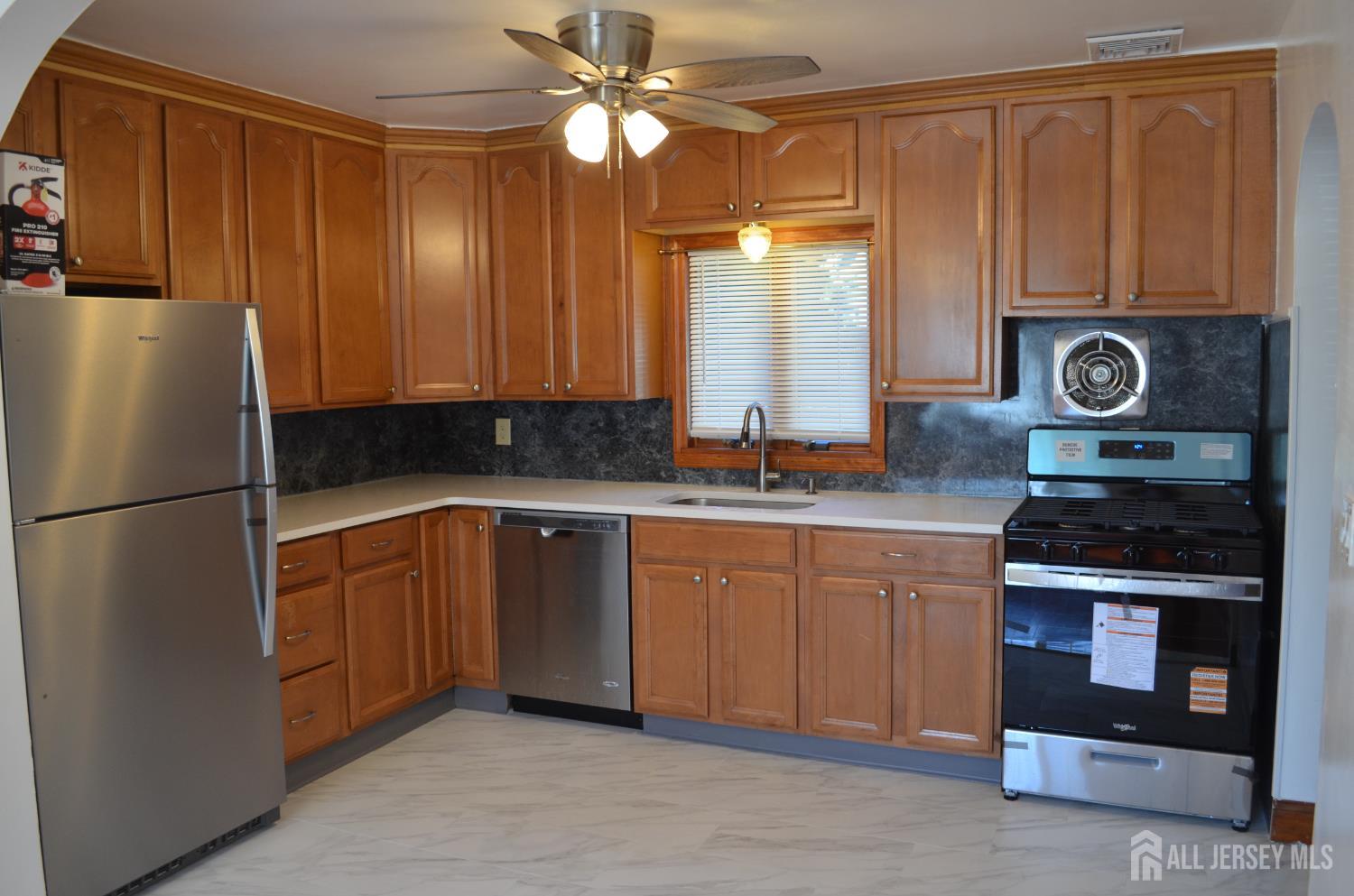 550 4th Street Dunellen, NJ 08812 - Photo 24 of 30 a kitchen with stainless steel appliances granite countertop a refrigerator a stove and a sink