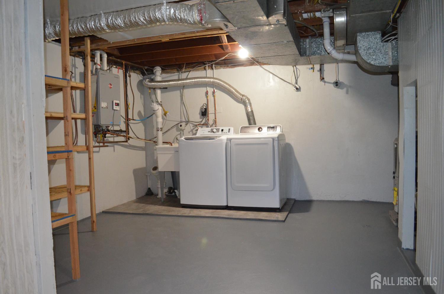 550 4th Street Dunellen, NJ 08812 - Photo 25 of 30 a view of storage and utility room with racks on the wall