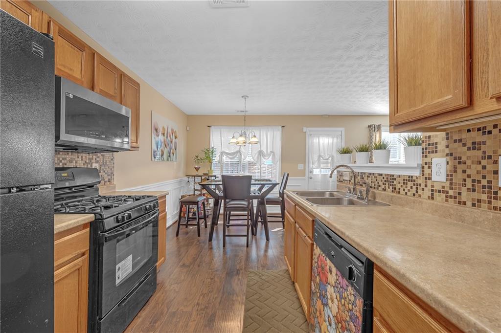 642 Lakes Circle Lithonia, GA 30058 - Photo 12 of 26 a kitchen with granite countertop lots of counter top space and stainless steel appliances