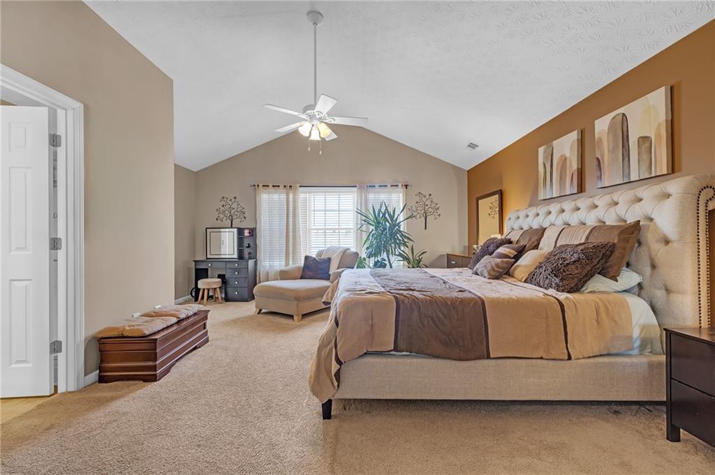 642 Lakes Circle Lithonia, GA 30058 - Photo 15 of 26 a spacious bedroom with a bed couch and a window