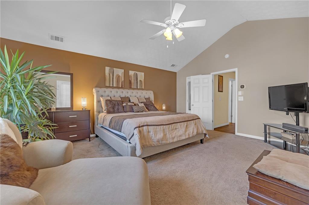 642 Lakes Circle Lithonia, GA 30058 - Photo 17 of 26 a bedroom with a large bed and a flat screen tv