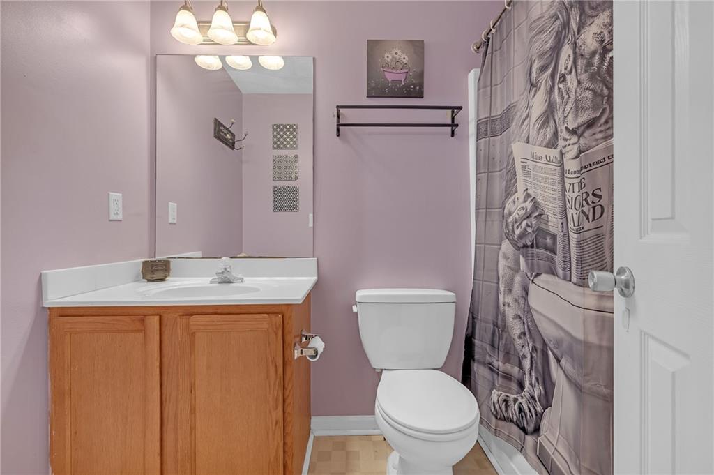 642 Lakes Circle Lithonia, GA 30058 - Photo 22 of 26 a bathroom with a granite countertop toilet sink and mirror