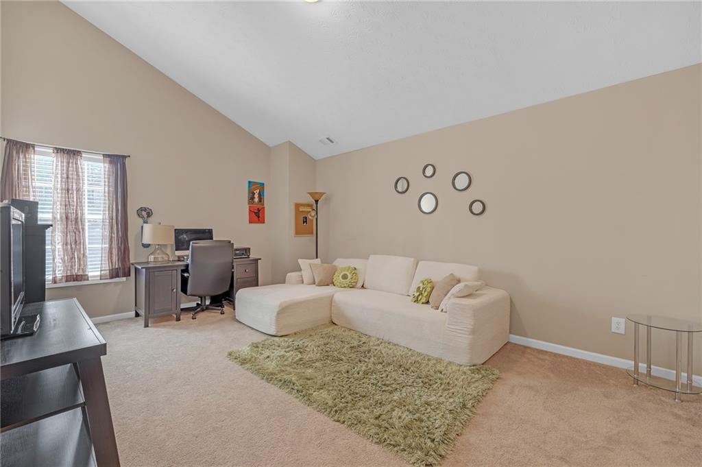 642 Lakes Circle Lithonia, GA 30058 - Photo 23 of 26 a living room with furniture and a flat screen tv
