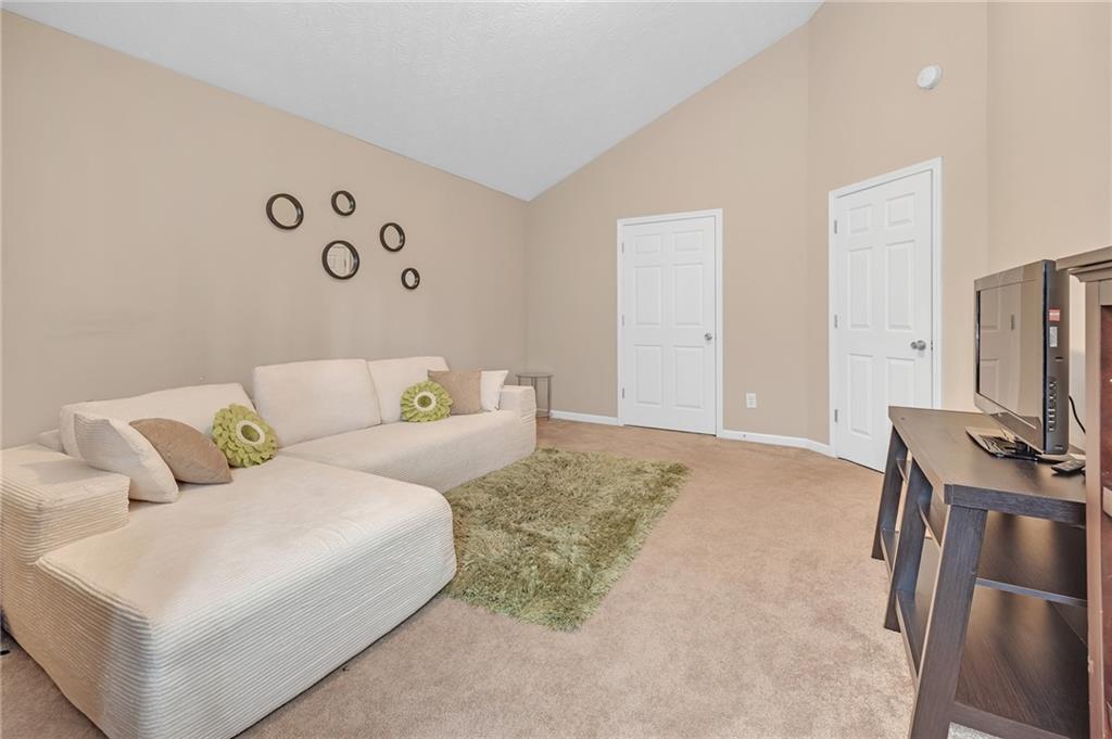 642 Lakes Circle Lithonia, GA 30058 - Photo 24 of 26 a living room with furniture and a flat screen tv