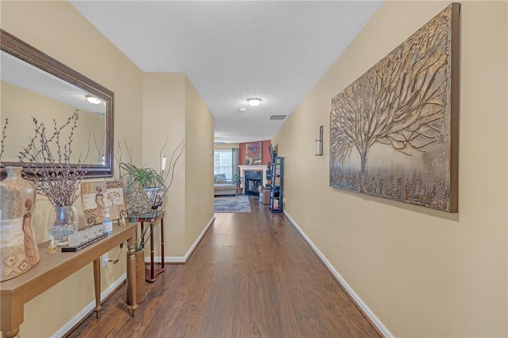 642 Lakes Circle Lithonia, GA 30058 - Photo 4 of 26 a view of a hallway with wooden floor and staircase