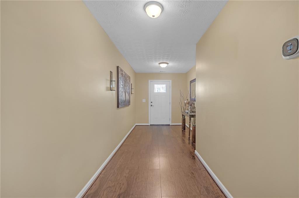 642 Lakes Circle Lithonia, GA 30058 - Photo 5 of 26 a view of a hallway with wooden floor and closet