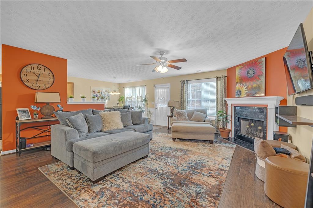 642 Lakes Circle Lithonia, GA 30058 - Photo 6 of 26 a living room with furniture a fireplace and a large window