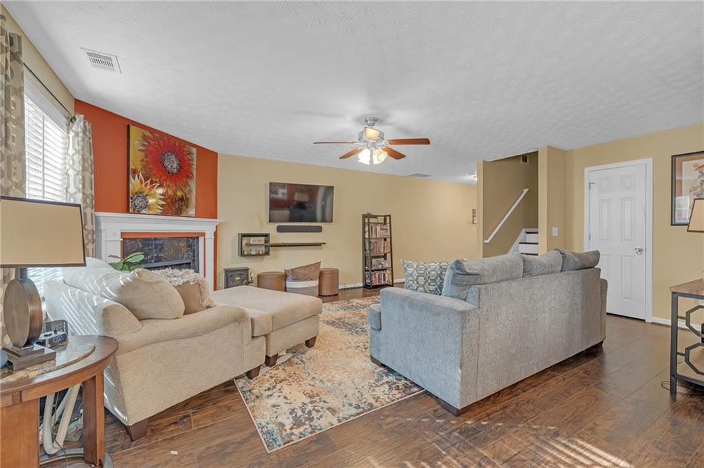 642 Lakes Circle Lithonia, GA 30058 - Photo 8 of 26 a living room with furniture a fireplace and a flat screen tv