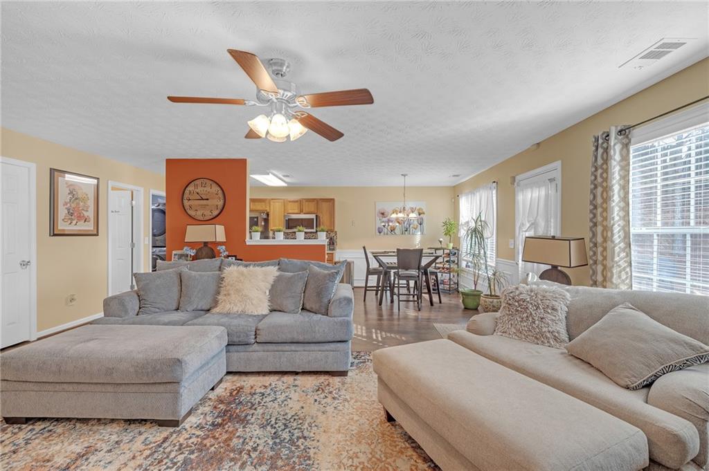 642 Lakes Circle Lithonia, GA 30058 - Photo 9 of 26 a living room with furniture and a large window